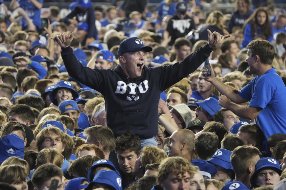 BYU fans storm the field and celebrate BYU's overtime win over Baylor after an NCAA college football game, Saturday, Sept. 10, 2022, in Provo, Utah. (AP Photo/George Frey)