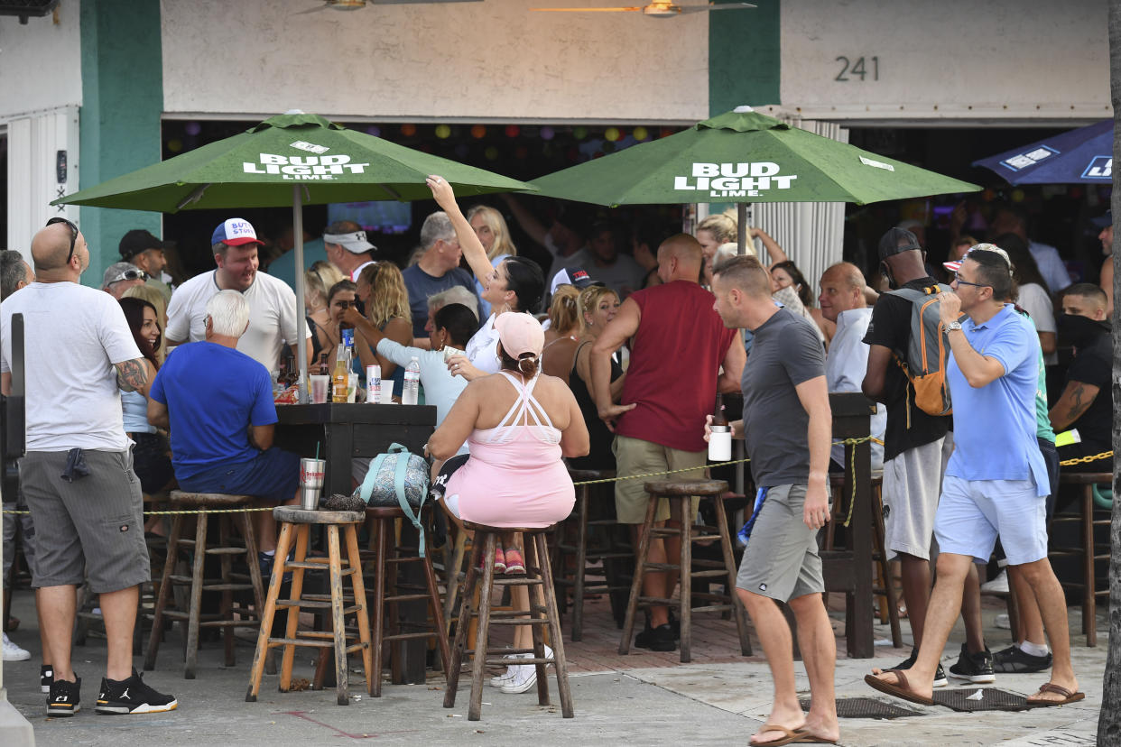 People seen partying at the Elbo Room after Florida Gov. Ron DeSantis announced that effective immediately, Florida moves to phase 3 of coronavirus reopening plan with bars and restaurants at full capacity on September 26, 2020 in Fort Lauderdale, Florida. (mpi04/MediaPunch /IPX via AP)