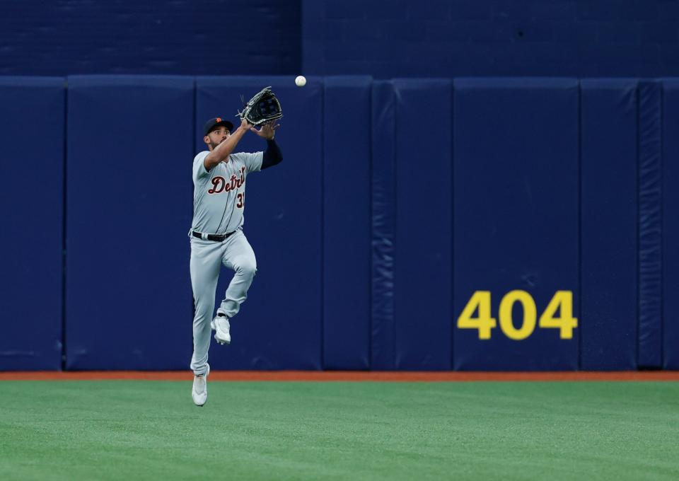 Detroit Tigers center fielder Riley Greene leaps to field a ball during the first inning against the Tampa Bay Rays, Saturday, April 1, 2023, in St. Petersburg, Fla.