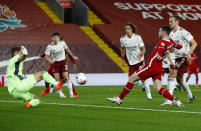 Liverpool's Andrew Robertson, second right, scores his teams second goal during the English Premier League soccer match between Liverpool and Arsenal at Anfield in Liverpool, England, Monday, Sept. 28, 2020. (Jason Cairnduff/Pool via AP)