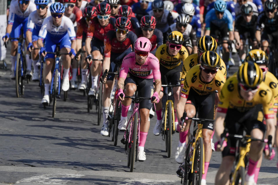 FILE - Primoz Roglic of Slovenia, center, wears the overall leader's pink jersey as he rides in the pack during the 21st and last stage of the Giro D'Italia, tour of Italy cycling race, in Sunday, May 28, 2023. (AP Photo/Alessandra Tarantino, File)