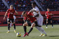 Real Madrid's Vinicius Junior, right, challenges for the ball with Mallorca's Pablo Maffeo during a Spanish La Liga soccer match between Mallorca and Real Madrid at the Son Moix stadium in Palma de Mallorca, Spain, Sunday, Feb. 5, 2023. (AP Photo/Francisco Ubilla)