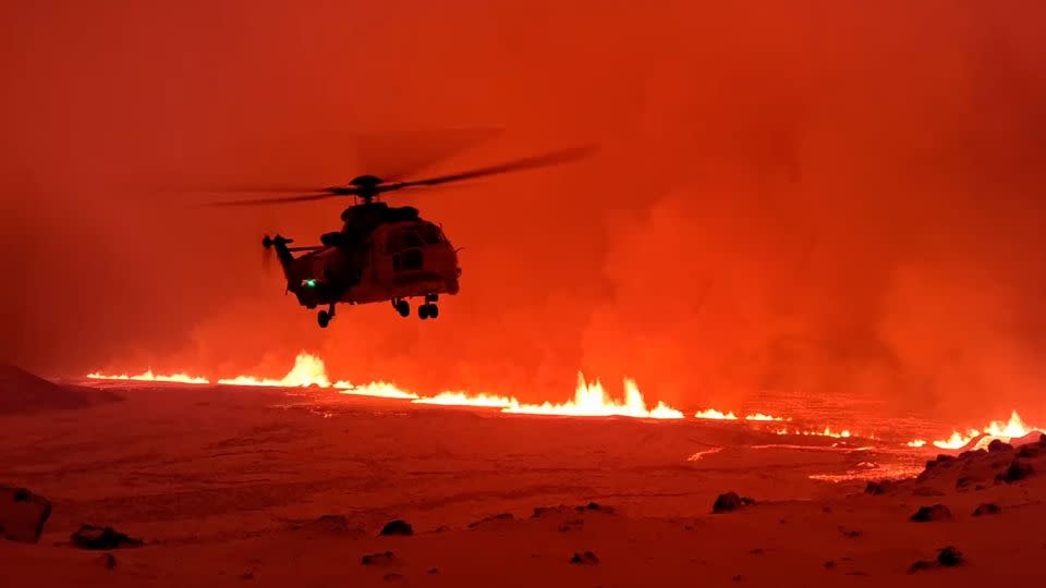 The Icelandic Coast Guard flies a helicopter over the site of the volcanic eruption in Sundhnuk, Iceland on December 19, 2023. - Icelandic Coast Guard