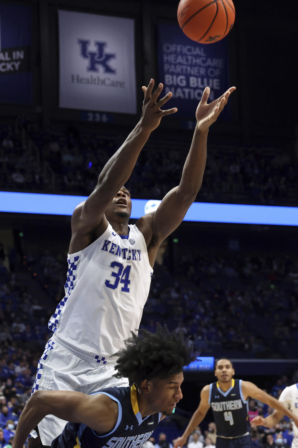 Kentucky's Oscar Tshiebwe (34) goes for a rebound above Southern University's P.J. Byrd during the first half of an NCAA college basketball game in Lexington, Ky., Tuesday, Dec. 7, 2021. (AP Photo/James Crisp)