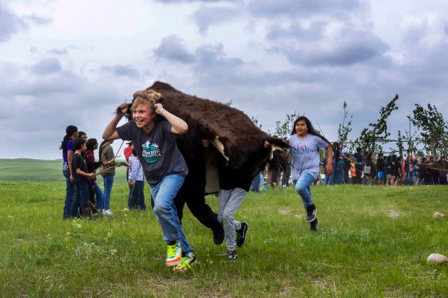 Young folks reenact a buffalo jump on June 2, 2023. 