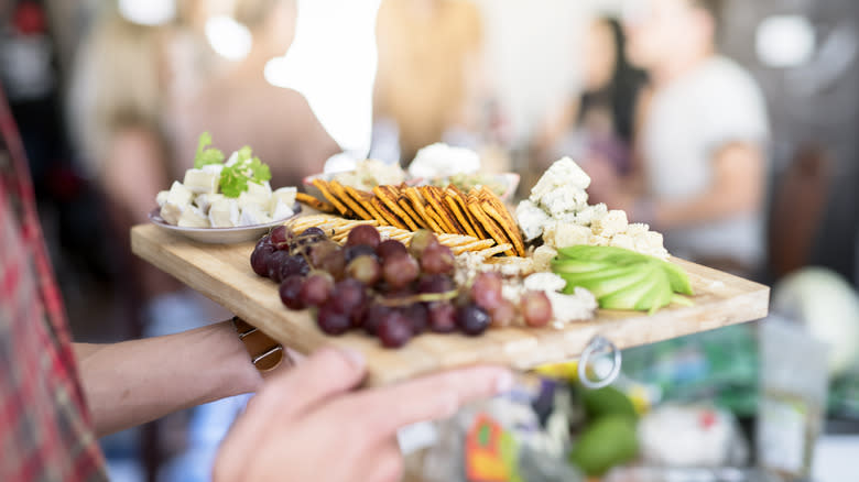 Person holding a charcuterie board