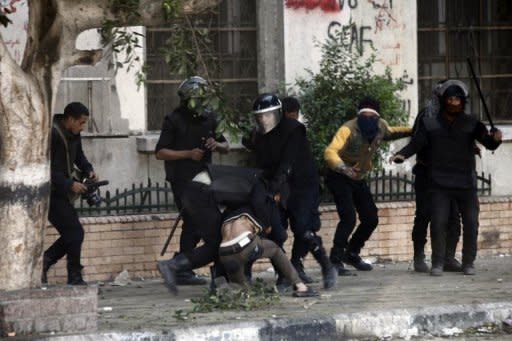 Egyptian riot police detain a man during clashes on Omar Makram street, off Tahrir Square, on November 28, in Cairo. A divisive panel boycotted by liberals and Christians was set to vote on a draft new Egyptian constitution, amid mounting protests over President Mohamed Morsi's assumption of sweeping powers