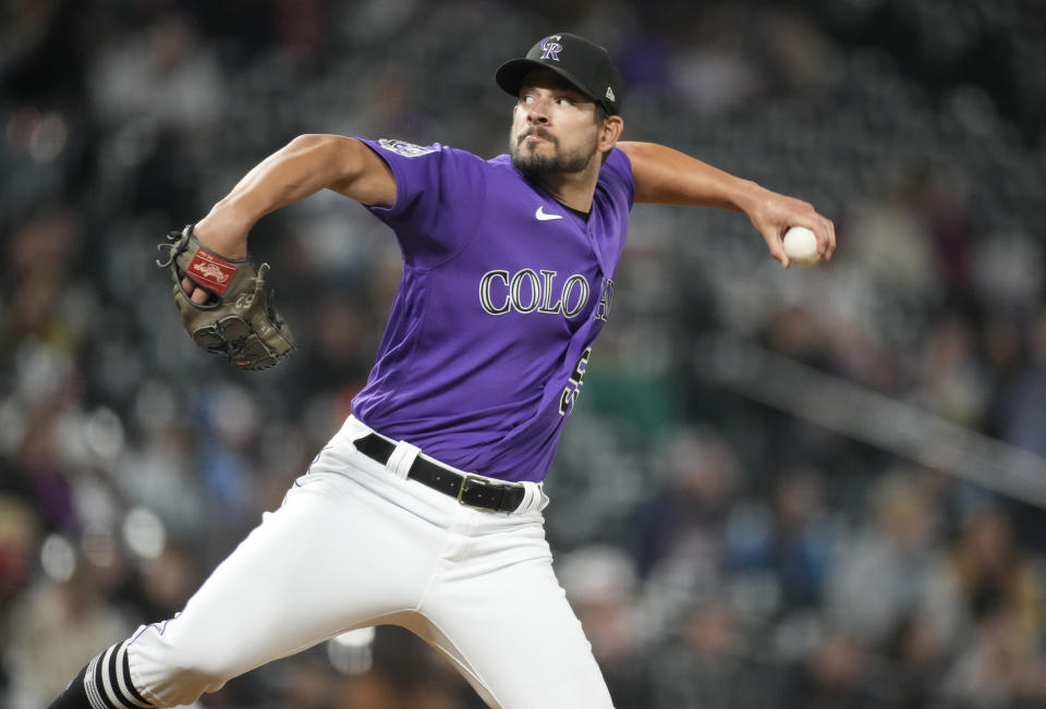 Colorado Rockies relief pitcher Brad Hand works against the Washington Nationals in the ninth inning of a baseball game Friday, April 7, 2023, in Denver. (AP Photo/David Zalubowski)