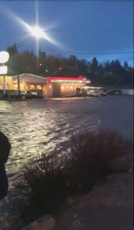 Floodwaters flow along a street in Pullman, Washington, U.S. in this still image taken from April 9, 2019 social media video. ELLIE STENBERG/via REUTERS