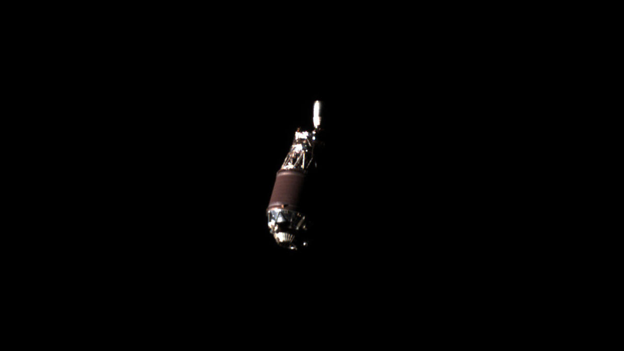  Up-close photo of a rocket upper stage in the blackness of space. 