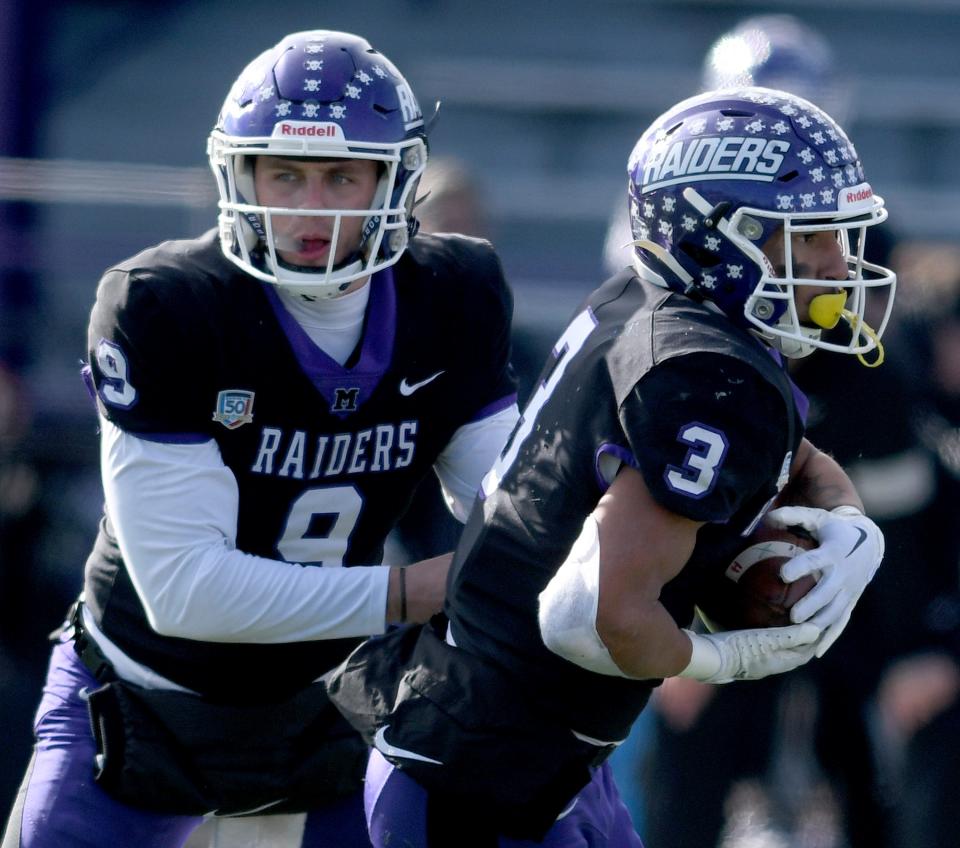Mount Union quarterback Braxton Plunk passes off the ball to running back DeAndre Parter in the second quarter of Mount Union vs Alma in NCAA Division III playoff at Mount Union. Saturday, November 25, 2023.