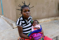 An internally displaced Congolese woman holds her child as they await post-natal care at the Kapangu maternity health centre in Kaniki-Kapangu near Mwene Ditu in Kasai Oriental Province in the Democratic Republic of Congo, March 15, 2018. Picture taken March 15, 2018. REUTERS/Thomas Mukoya