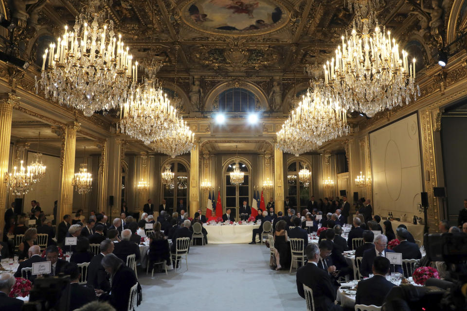 French President Emmanuel Macron, third right, speaks flanked by his wife Brigitte Macron, second left, Chinese President Xi Jinping third left, his wife Peng Liyuan , second right, French Prime Minister Edouard Philippe, right, and President of the French National Assembly RIchard Ferrand, left, during a state dinner at the Elysee Palace in Paris, France, Monday, March 25, 2019. Chinese President Xi Jinping is on a 3-day state visit in France where he is expected to sign a series of bilateral and economic deals on energy, the food industry, transport and other sectors. (Ludovic Marin/Pool Photo via AP)