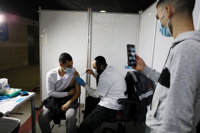 A man receives a vaccination against the coronavirus disease (COVID-19) at a temporary Clalit healthcare maintenance organisation (HMO) vaccination centre in Jerusalem