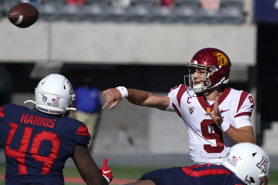 Southern California quarterback Kedon Slovis (9) throws over Arizona linebacker Jalen Harris (49) in the first half during an NCAA college football game, Saturday, Nov. 14, 2020, in Tucson, Ariz. (AP Photo/Rick Scuteri)