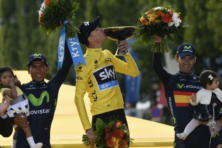 Tour de France 2015's winner Great Britain's Christopher Froome (C), second-placed Colombia's Nairo Quintana (L) and third-placed Spain's Alejandro Valverde, celebrate on the podium on the Champs-Elysees avenue in Paris