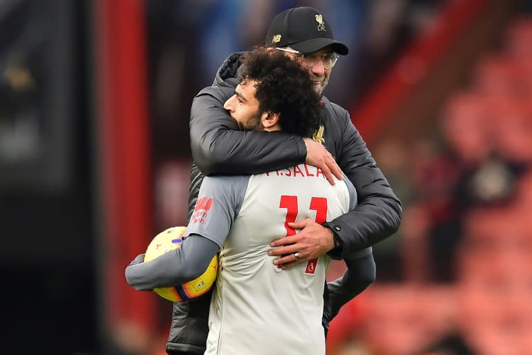 Liverpool forward Mohamed Salah holds the match ball after scoring a hat-trick against Bournemouth