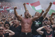 Hungarian fans celebrate after Attila Fiola scored his side's opening goal, during the Euro 2020 soccer championship group F match between Hungary and France, at the Ferenc Puskas stadium in Budapest, Saturday, June 19, 2021. (Alex Pantling, Pool via AP)