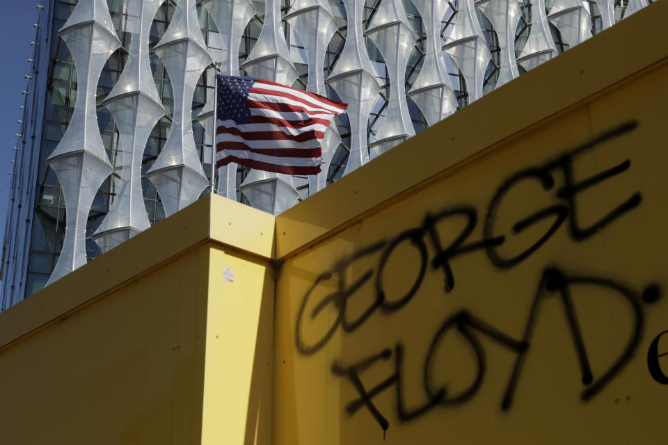 FILE - In this Sunday, May 31, 2020 file photo George Floyd's name stands written outside the U.S. embassy after people marched there from Trafalgar Square in central London to protest against the recent killing of George Floyd in Minneapolis, USA. (AP Photo/Matt Dunham, File)