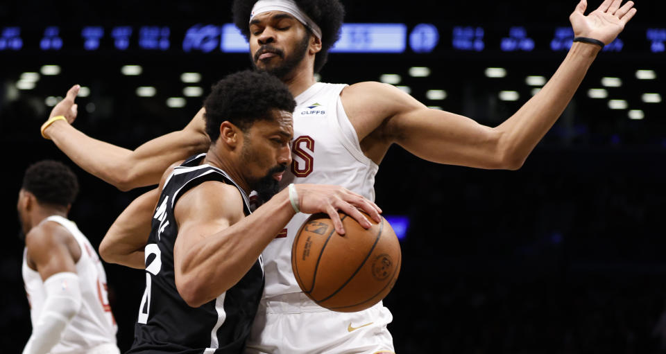 Brooklyn Nets guard Spencer Dinwiddie (26) drives to the basket against Cleveland Cavaliers center Jarrett Allen (31) during the second half of an NBA basketball game, Tuesday, March 21, 2023, in New York. The Cleveland Cavaliers won 115-109 (AP Photo/Noah K. Murray)