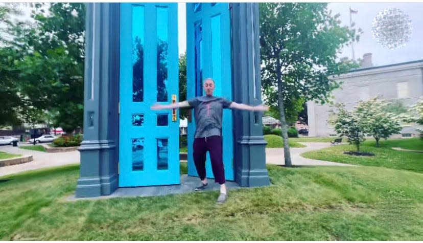 Actor Alan Cumming stands in front of DATMA's 'Threshold' public art piece on Saturday.