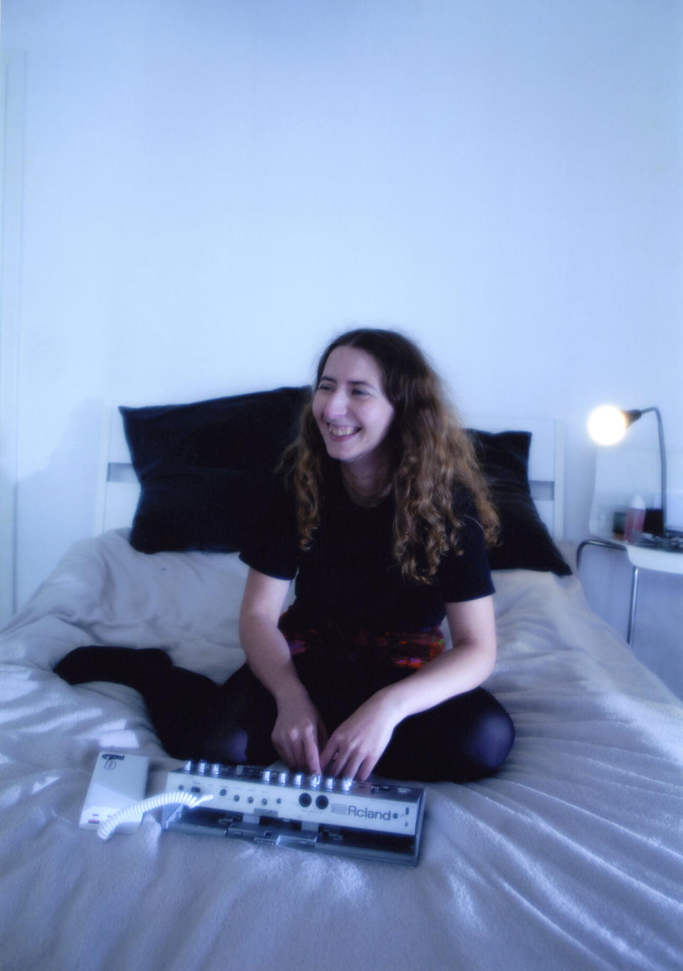 Poly Chain smiles as she fiddles around with a synthesizer (Photo credit: Nastya Platinova)