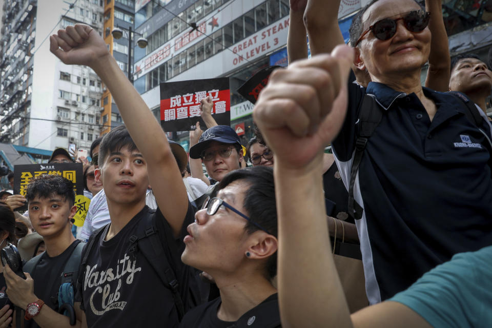 Protesters gestures during a march on a street in Hong Kong, Sunday, July 21, 2019. Thousands of Hong Kong protesters marched from a public park to call for an independent investigation into police tactics. (AP Photo/Vincent Yu)