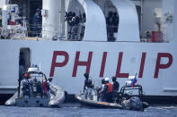 Armed Philippine Coast Guard personnel stand guard on board the PCG Melchora Aquino ship during a Coast Guard drill off the waters of Bataan, Philippines., Tuesday, June 6, 2023. U.S., Japan and Philippine coast guard ships staged law enforcement drills in waters near the disputed South China Sea on Tuesday as Washington pressed efforts to reinforce alliances in Asia amid an increasingly tense rivalry with China.(AP Photo/Aaron Favila)