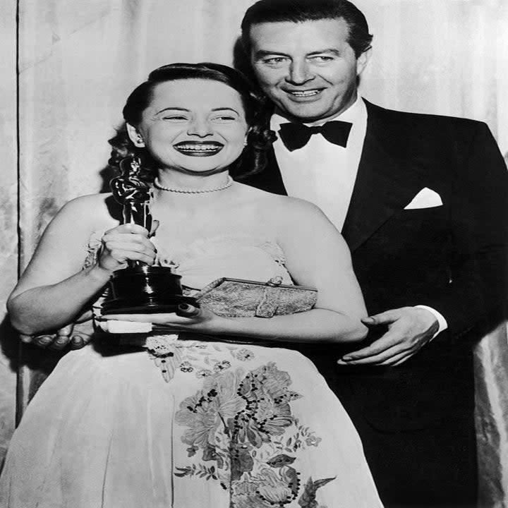 closeup of Mary and her partner posing with her award