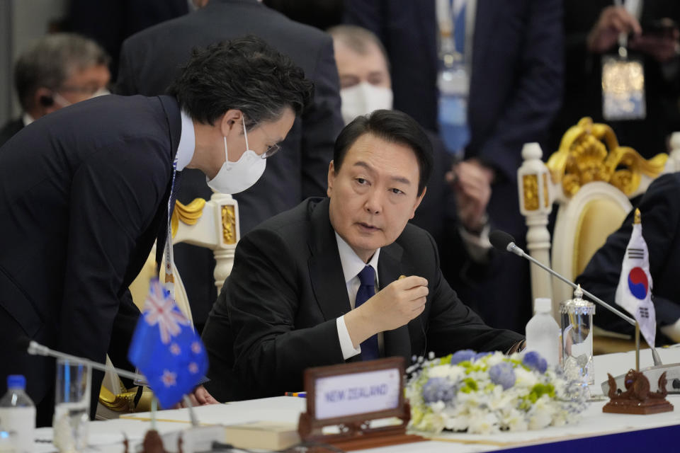 FILE - South Korea's President Yoon Suk Yeol, center, talks with his staff during the ASEAN - East Asia Summit in Phnom Penh, Cambodia on Nov. 13, 2022. The United States and its two top Asian allies have been working quietly on the sidelines of this week’s Group of 20 meetings in Bali, Indonesia, to raise the issue of North Korea’s growing aggressiveness and build a broader coalition of like-minded states to help maintain international pressure on it. (AP Photo/Vincent Thian, File)