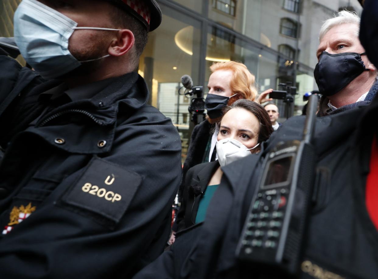 Stella Moris girlfriend of Julian Assange is escorted by police after speaking to the media outside the Old Bailey in London on Monday, Jan. 4, 2021. A British judge has rejected the United States' request to extradite WikiLeaks founder Julian Assange to face espionage charges, saying it would be "oppressive" because of his mental health. District Judge Vanessa Baraitser said Assange was likely to commit suicide if sent to the U.S. The U.S. government said it would appeal the decision.
