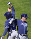 Tampa Bay Rays' Willy Adames (1) is greeted near the dugout by Hunter Renfroe after hitting a solo home run off Baltimore Orioles starting pitcher John Means during the fourth inning of a baseball game, Sunday, Sept. 20, 2020, in Baltimore. (AP Photo/Julio Cortez)