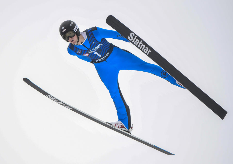 Kevin Bickner soars through the air during the men's ski jumping competition at the Olympic Ski Jumping Complex in Lake Placid, N.Y., Saturday, Dec. 25, 2021. Bickner won the U.S. trials last month, helping him earn a trip to the Olympics for the second time. The 25-year-old Bickner, who learned how to jump in suburban Chicago at the Norge Ski Club, finished 18th on the normal hill and 20th on the large hill at the Pyeongchang Games.(AP Photo/Hans Pennink)