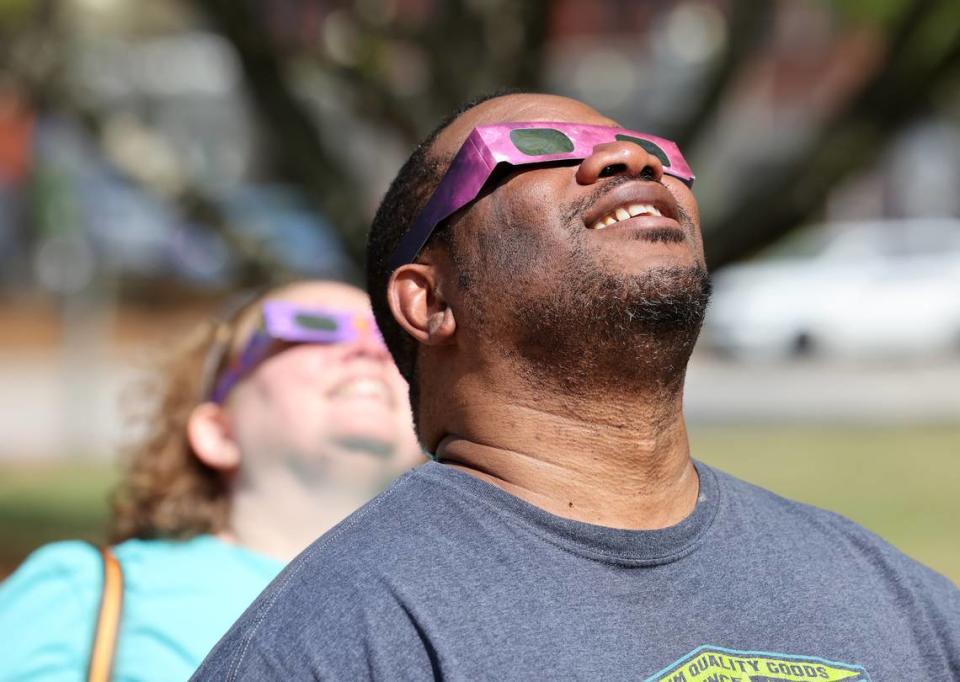 Durant Cameron, right, and Grace Cameron watch the solar eclipse with special glasses Monday at the Old Town Amphitheater in downtown Rock Hill.