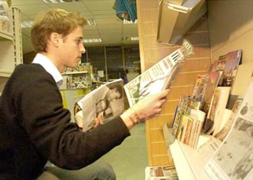 Just browsing: Prince William selects his reading matter during a break from his end of year exams at St Andrews University <br></br>Â© PA: 