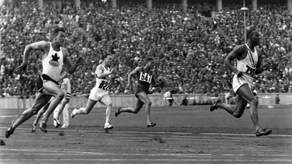 Owens (right) competes in the 200m preliminary heats at the 1936 Olympic Games. - DHM/ullstein bild/Getty Images)