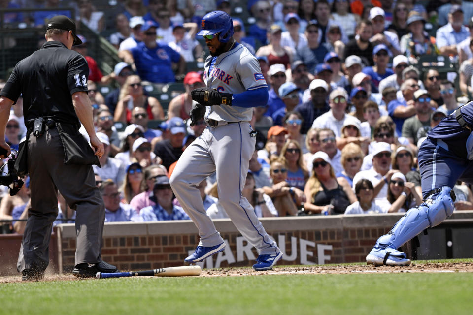 New York Mets' Starling Marte scores during the third inning of a baseball game against the Chicago Cubs, Friday, June 21, 2024, in Chicago. (AP Photo/Matt Marton)