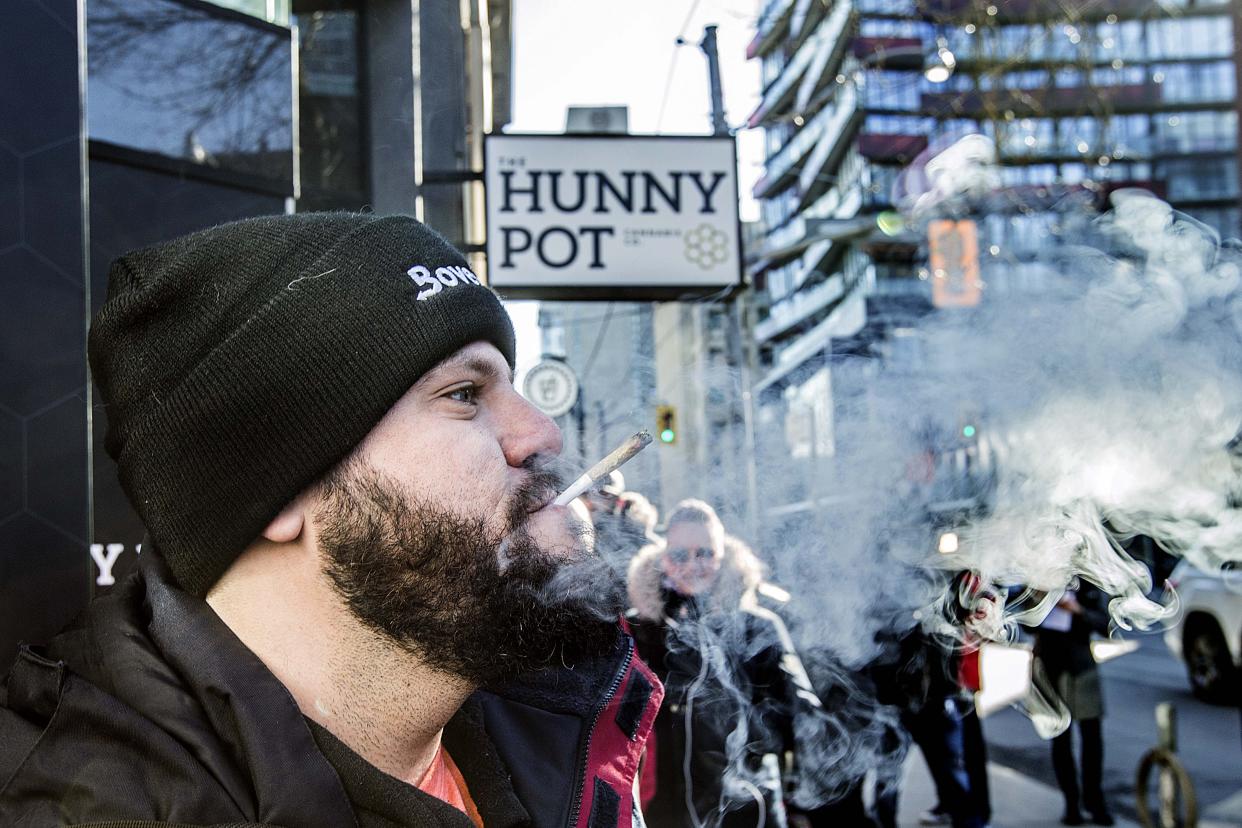 TORONTO, ON - APRIL 1:  Cannaibis educator Jonathan Hirsh smokes a joint he purchased outside the Hunny Pot Cannabis Co. store at 202 Queen St. W.        (Andrew Francis Wallace/Toronto Star via Getty Images)