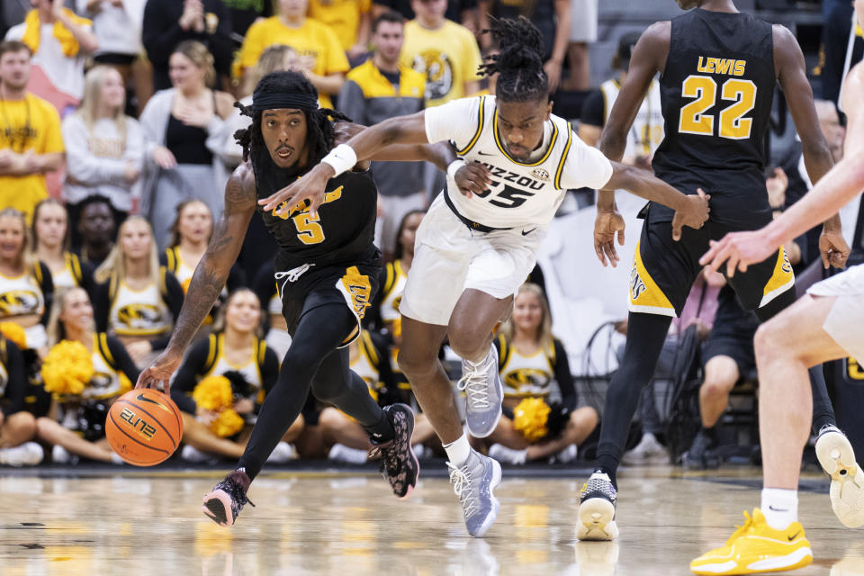 Arkansas-Pine Bluff's Rashad Williams, left, collides with Missouri's Sean East II, right as he brings the ball up court during the first half of an NCAA college basketball game Monday, Nov. 6, 2023, in Columbia, Mo. (AP Photo/L.G. Patterson)