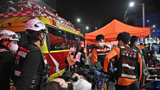 PHOTO: Medical staff attend to a person on a stretcher after dozens were injured in a stampede, after people crowded into narrow streets in the city's Itaewon neighbourhood to celebrate Halloween, in Seoul,  South Korea, on Oct. 30, 2022. (Anthony Wallace/AFP via Getty Images)