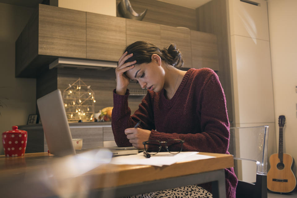 exhausted young woman working at home