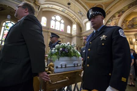 Chicago police officers are pallbearers for an abandoned newborn baby boy during a funeral mass at St. Hyacinth Basilica in Chicago, Illinois, United States, June 19, 2015. REUTERS/Jim Young