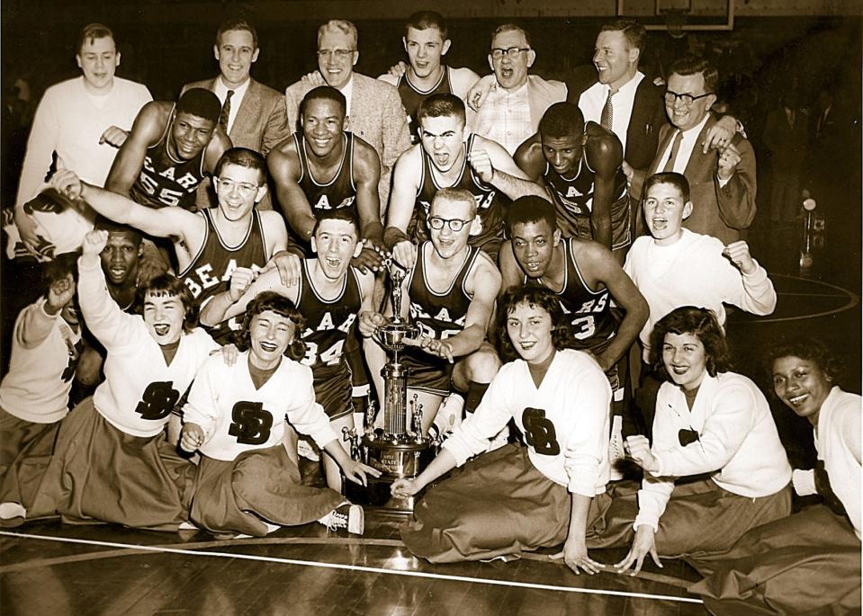 Members of the 1957 South Bend Central High School boys’ basketball team celebrate their state championship following a 30-0 season.