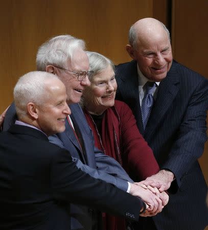 Roberta Buffett Elliott (2nd R) is joined by her brother Warren Buffett (2nd L), her husband David Elliott (R) and Northwestern University President Morton Schapiro during an announcement ceremony at Northwestern University in Evanston, Illinois, January 28, 2015. REUTERS/Jim Young