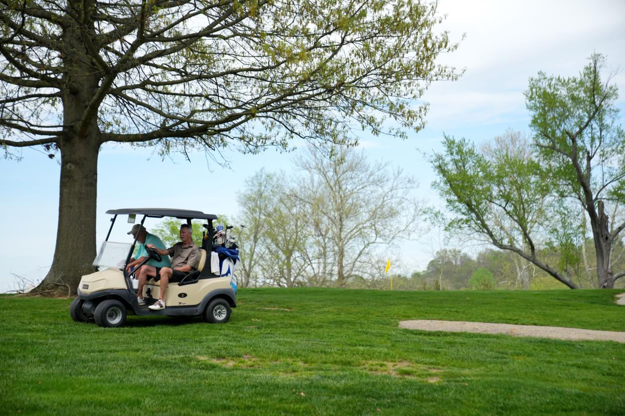 Two golfers ride toward the parking lot at California Golf Course, Tuesday, April 16, 2024, in Cincinnati. The high-profile Cincinnati Futures Commission tasked with charting the future for Cincinnati's leaders recommended the city regionalize its water system, write more parking tickets, turn two parks over to the county, lease out Lunken Airport and sell its public golf courses.