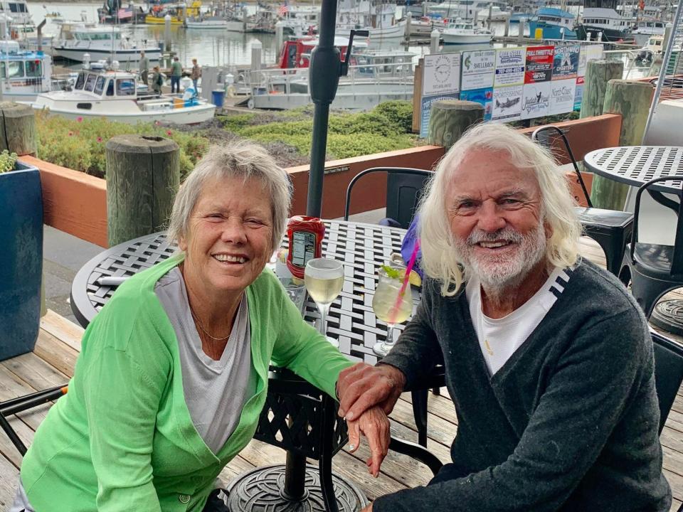 Louisa Rogers and her husband Barry on their 44th wedding anniversary sitting outside at a cafe table. When Louisa Rogers and her husband Barry decided to combine their finances, it improved their marriage.