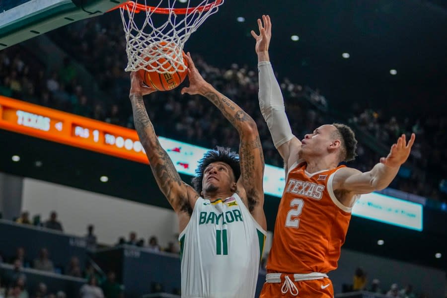 Baylor’s Jalen Bridges (11) goes up for a basket against Texas’s Chendall Weaver (2) during the first half of an NCAA college basketball game, Monday, March 4, 2024, in Waco, Texas. (AP Photo/Julio Cortez)