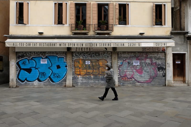 A person walks in a nearly empty Venice after Italy tightened the lockdown measures to combat the coronavirus disease (COVID-19) outbreak in Venice