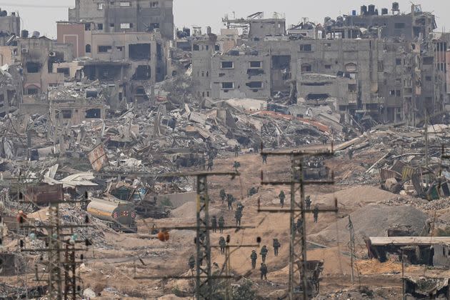 Israeli troops walk in Gaza as seen from southern Israel on Dec. 21. The army is battling Palestinian militants across Gaza in the war ignited by Hamas' Oct. 7 attack.