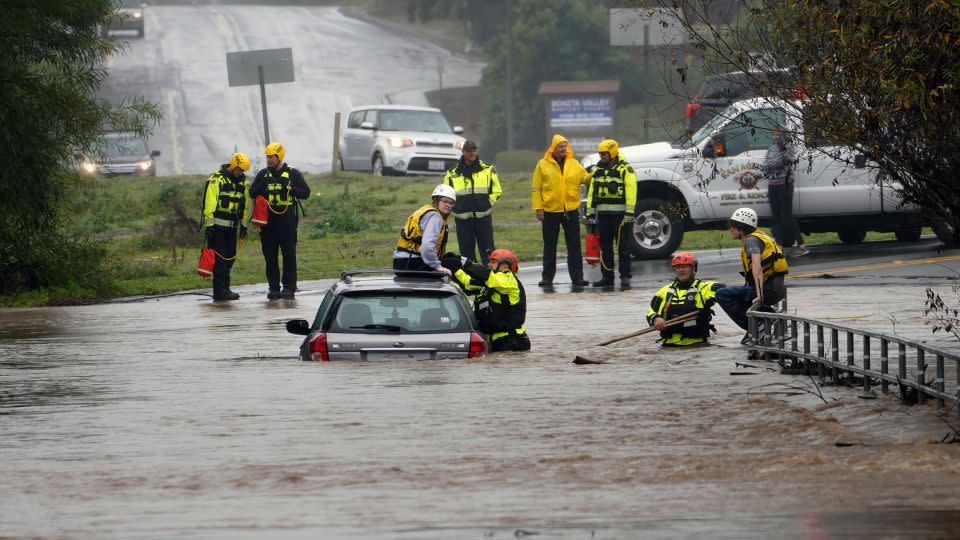  Emergency personnel rescued two individuals trapped on a flooded road in San Diego County. - Nelvin C. Cepeda/San Diego Union-Tribune/Zuma